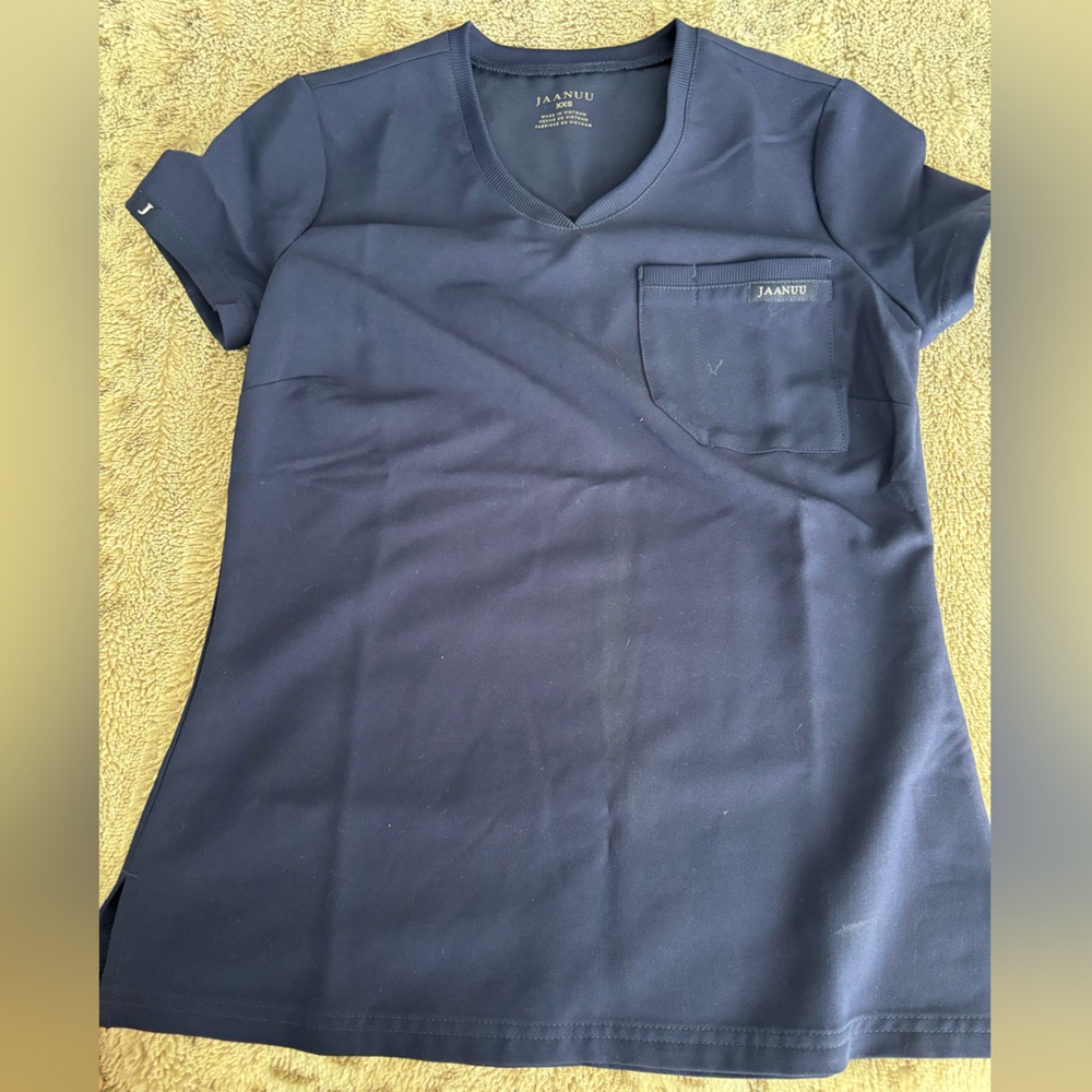 Jaanuu navy scrub top XXS. Fits more like an XS.